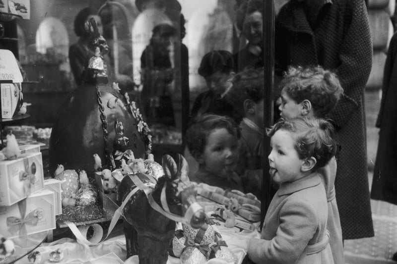 In 1952 a little boy finds it hard to contain his excitement at a giant Easter egg display in a sweet shop in Regent Street.  (Photo by Monty Fresco/Topical Press Agency/Getty Images)