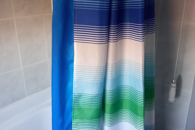 Using 2 shower curtains over your bath, clipped to one set of curtain hooks will save water splashing out. Use a cheap plastic waterproof one for inside the bath. Then, outside of the bath, hang a prettier one. This will look good but won't get mildew or go mouldy over time like the inner one. 