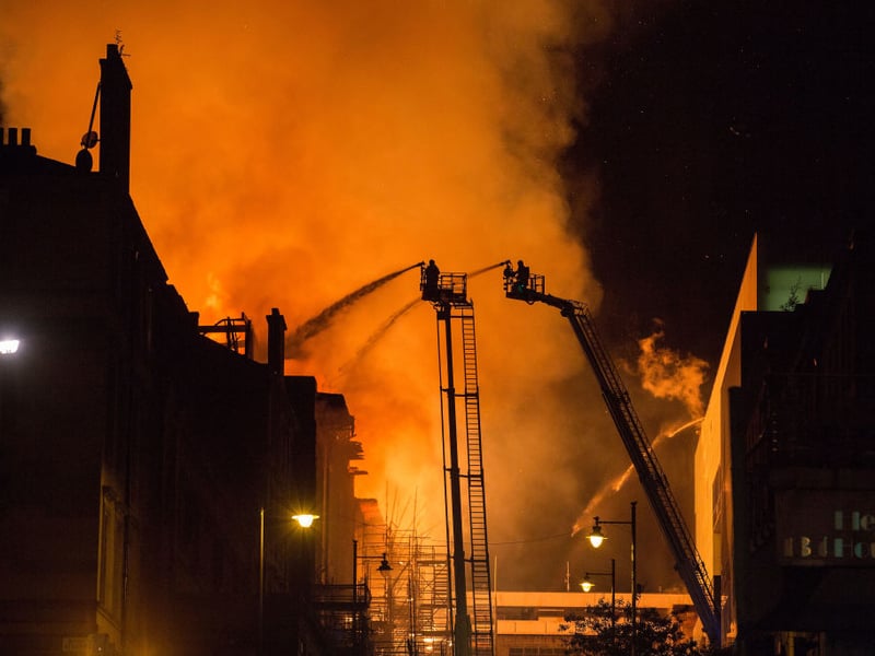 Brave firefighters tackled the significantly larger blaze from cherry pickers suspended at perilous heights.