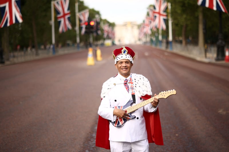 Royal Fan Andrew Thompson poses on The Mall prior to the King’s Birthday Parade. (Photo by HENRY NICHOLLS/AFP via Getty Images)