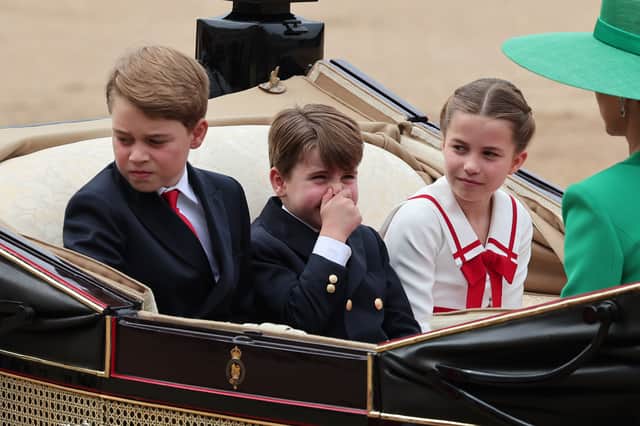 Prince George, Princess Charlotte and Prince Louis, who has apparently smelt something, ride in a horse drawn carriage with Catherine, Princess of Wales and Queen Camilla during Trooping the Colour at Horse Guards Parade. (Photo by Rob Pinney/Getty Images)