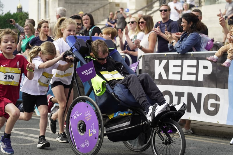 Rob Burrow MBE and daughters Macy and Maya take off from Parkinson Steps. Photo: Run For All