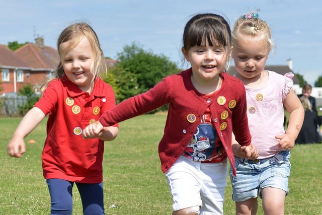 Georgina Jenkins, Tilly Corbett and Jasmine Cutting run together at the Cheeky Monkeys sports day in 2015.