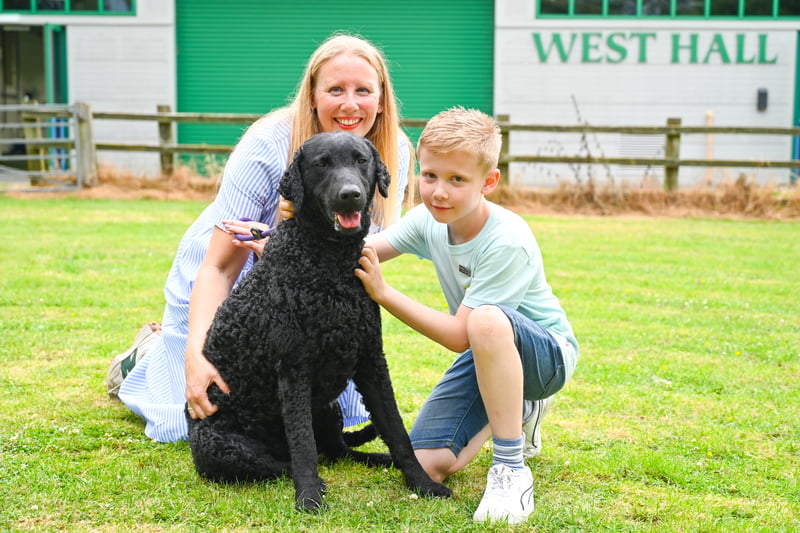 Vicki Hayes with her son, Reuben, and Curly Coated Retriever, Anise, winner of Best of Breed at the first ever Vulnerable Native Breed Show. (Photo - Heidi Hudson/The Kennel Club)
