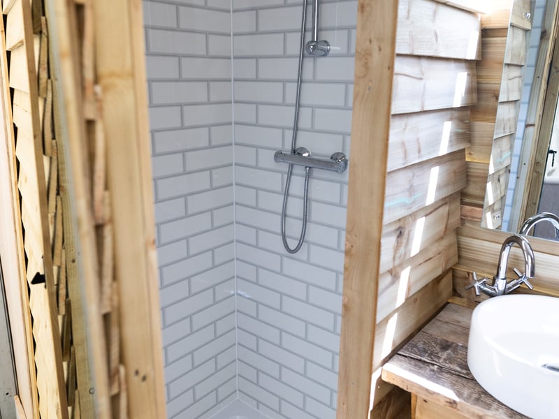 The pop-up hotel offers refreshing showers - a premium at Glastonbury