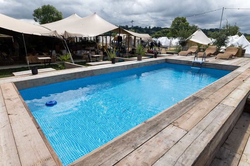 The premium tent features a nearby on-site swimming pool