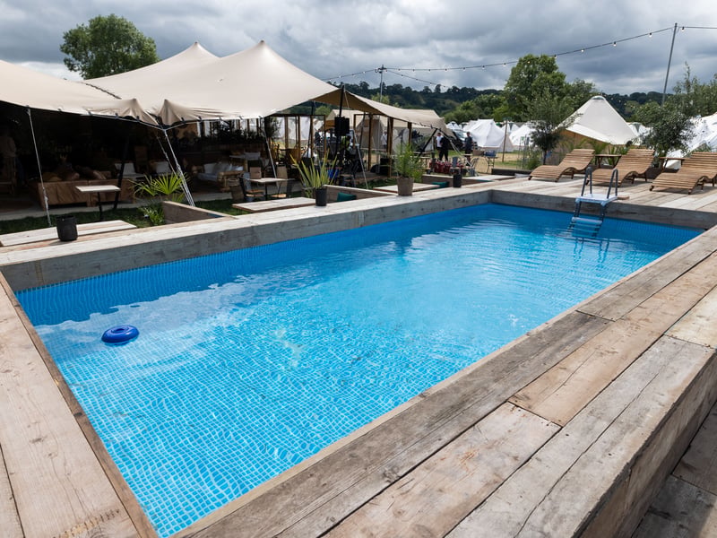 The premium tent features a nearby on-site swimming pool