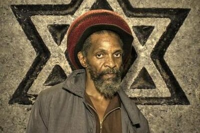 Jay Shaka moved to London from Jamaica as a child in the late 1950s as part of the Windrush generation. By the late 1970s, Shaka’s sound system had developed a cult following; he starred as himself with his system in the 1980 film Babylon. Non-reggae artists such as Basement Jaxx have cited Jah Shaka as being their best night out ever. Jah Shaka events were renowned for attracting a wide audience from all backgrounds, races and ages. His dances attracted numbers previously thought unthinkable for this genre of music.