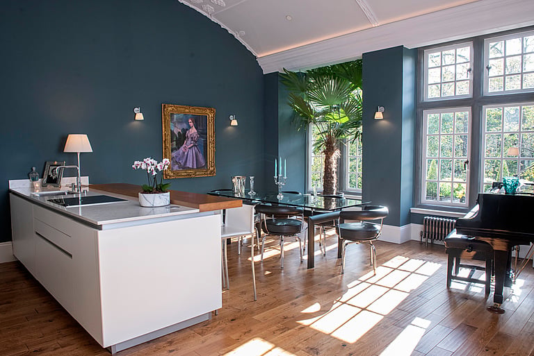 Homeowners Jason and John spent a lot of time restoring Kirklee Mansion to its former glory, maintaining key architectural details throughout. The couples favourite spot is an armchair called Lilibet which has the best views of their expansive living room and sits under a picture of Sir George Arthur Mitchell, the original owner of Kirklee Mansion.