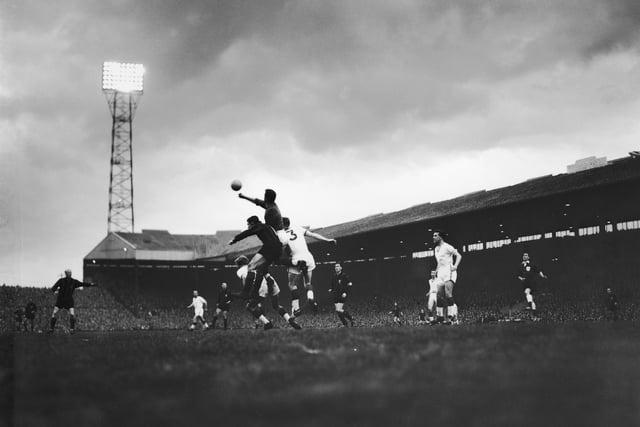 Manchester United keeper Harry Gregg punches a ball clear after an attack on goal during a match against AC Milan in the first leg of the European Cup semi-finals at Old Trafford, 9th May 1958. United won the match 2-1. (Photo by Keystone/Hulton Archive/Getty Images)