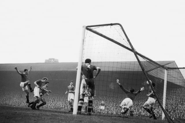 Manchester United centre forward Tommy Taylor (third from left) scores his team's third goal against Chelsea at Old Trafford, 1st January 1957. Chelsea goalkeeper Mathews and brothers John and Peter Sillett look on helplessly. Man U beat Chelsea 3-0. (Photo by Keystone/Hulton Archive/Getty Images)