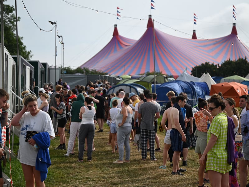 Festivalgoers queue for the showers on day 3 of the Glastonbury festival in the village of Pilton in Somerset, southwest England, on June 23, 2023. The festival takes place from June 21 to June 26. (Photo by Oli SCARFF / AFP) (Photo by OLI SCARFF/AFP via Getty Images)