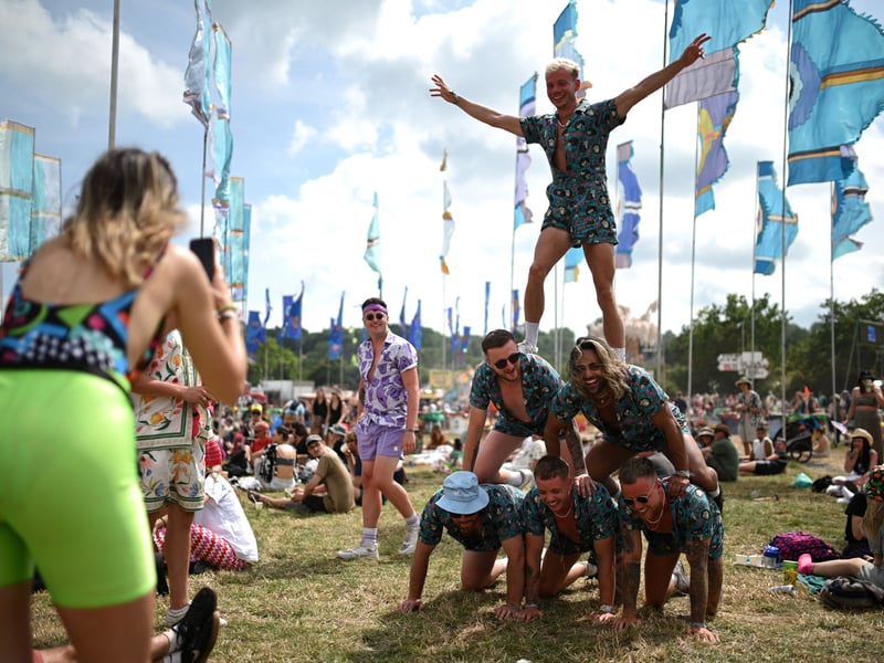 Festivalgoers build a human pyramid on day 3 of the Glastonbury festival in the village of Pilton in Somerset. (Photo by OLI SCARFF/AFP via Getty Images)
