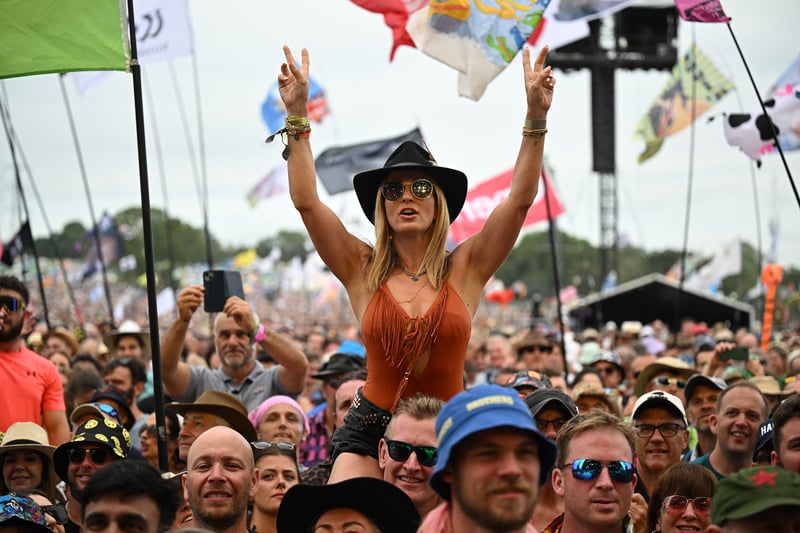 Festivalgoers wait to hear bands perform on the Pyramid Stage on day 3 of the Glastonbury festival.(Photo by OLI SCARFF/AFP via Getty Images)