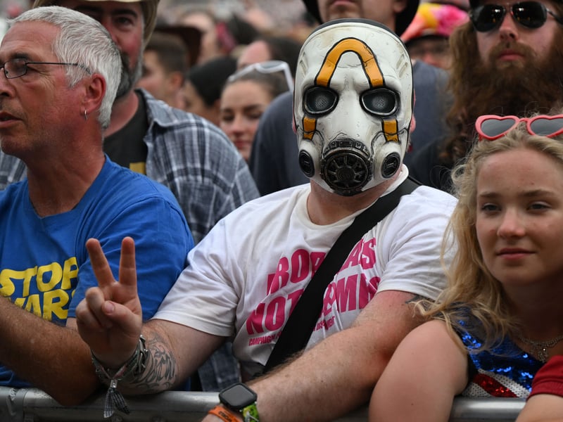 Festivalgoers wait to hear bands perform on the Pyramid Stage on day 3 of the Glastonbury festival. (Photo by OLI SCARFF/AFP via Getty Images)