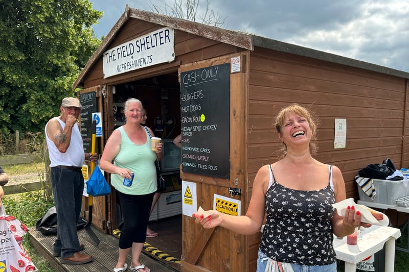 Nikki Lewis runs the food stall. It started as a gazebo, but now its a wooden hut and today she’s busy selling everything from coffee to hot dogs to hungry buyers and sellers. 