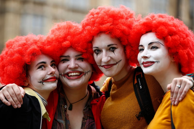 Demonstrators dressed as Ronald McDonald in a protest over working conditions and the use of zero-hour contracts. (Photo by TOLGA AKMEN/AFP via Getty Images)