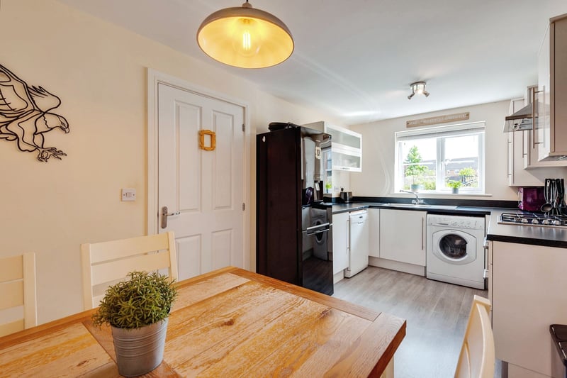 There is a stylish and modern fitted kitchen with a range of wall and base units, gas hob inset to worktop, integrated oven and space for dining table and chairs with views of the front garden.