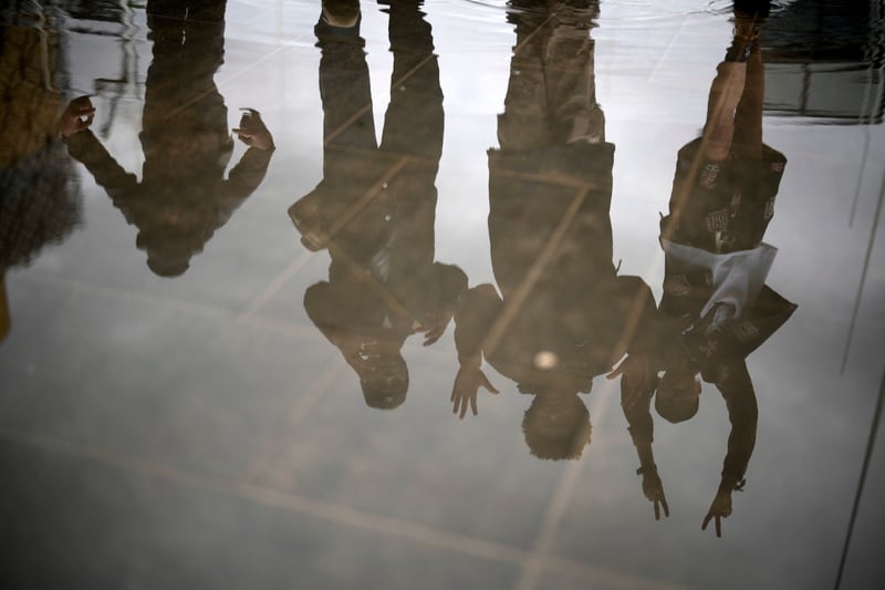 Members of the UPG dance collective and Tarju Le’Sano, right, director of the 93:00 Collective, are reflected in the Centenary Square foiuntains after performing at the launch for the Birmingham Festival 23 on June 28, 2023 in Birmingham, England. (Photo by Christopher Furlong/Getty Images)