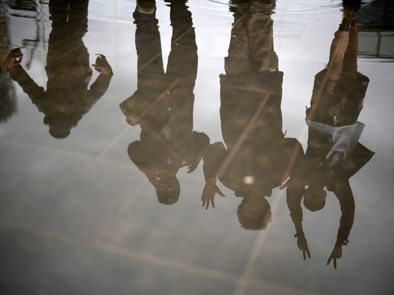 Members of the UPG dance collective and Tarju Le’Sano, right, director of the 93:00 Collective, are reflected in the Centenary Square foiuntains after performing at the launch for the Birmingham Festival 23 on June 28, 2023 in Birmingham, England. (Photo by Christopher Furlong/Getty Images)