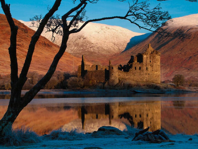 Kilchurn Castle is a ruin that sits on a rocky peninsula next to Loch Awe in Argyll and Bute. It was first constructed around 1450 by Sir Colin Campbell, first Lord of Glenorchy, as a five-storey tower house with a courtyard defended by an outer wall. It was used as the base for the Campbells of Glenorchy.