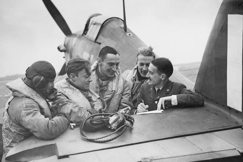 Pilots on the tailplane of a Hawker Hurricane MkI fighter on December 10, 1940 at Liverpool Airport.
