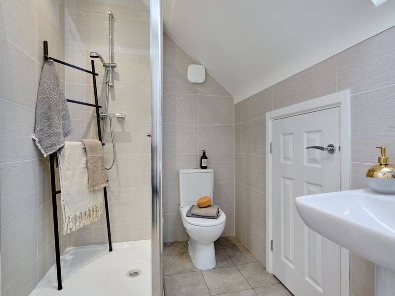 The master bedroom has its own ensuite bathroom with a shower.