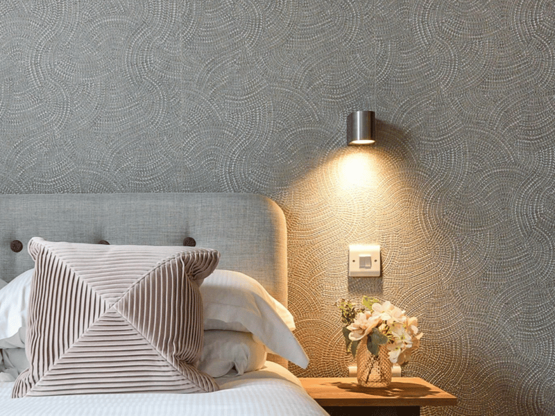 The room features hotel-style wall lights