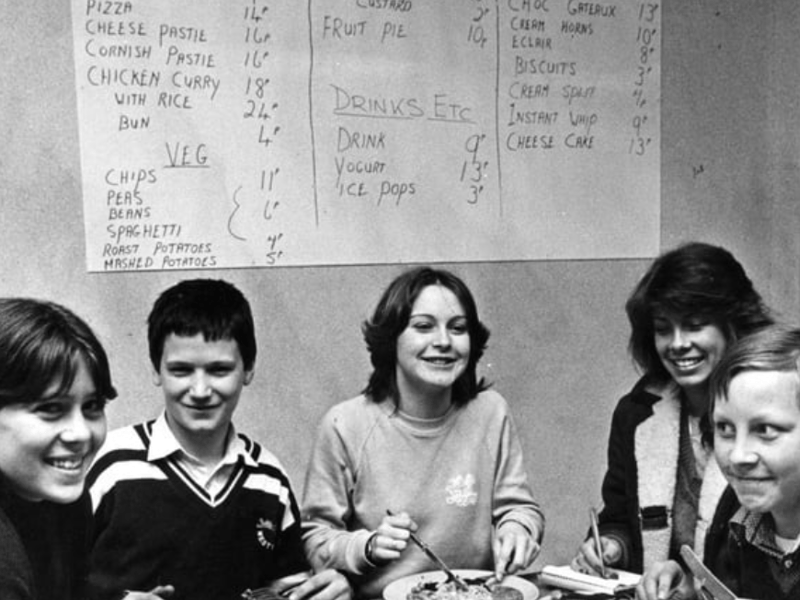 Look at the dinnertime bargains at South Shields Comprehensive School. Chicken curry with rice for 42 pence and pizza and chips for 25 pence! Pictured at the dining table are left to right Dawn Fada, George Scorer, Angela Scott and Thomas Rear. Reporter Diane Rose is pictured taking notes in 1981. Photo: Shields Gazette