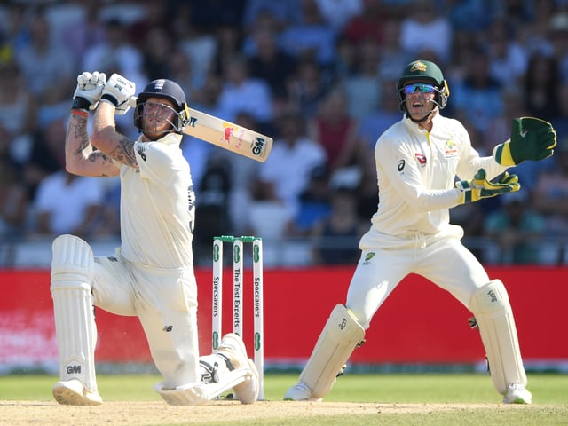 AUGUST 25: England batsman Ben Stokes hits a ball for 6 runs watched by Tim Paine during day four of the 3rd Ashes Test Match between England and Australia at Headingley on August 25, 2019 in Leeds, England. (Photo by Stu Forster/Getty Images)