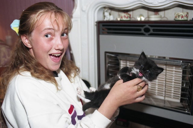 Gemma Cubby with six week old kitten Lucy in 1998.  
Firefighters rescued Lucy from behind her owner's fireplace.