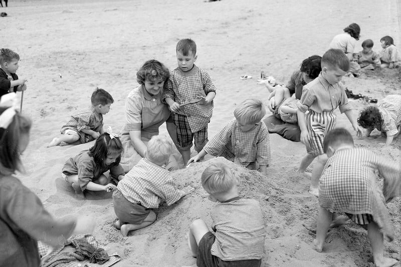 Children from Niddrie Day Nursery, in Edinburgh, during an outing to Gullane Beach in July 1959.