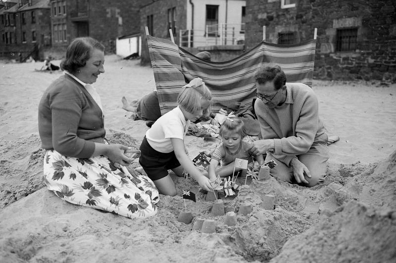 A family of holidaymakers at North Berwick, in East Lothian, building sandcastles in 1959.