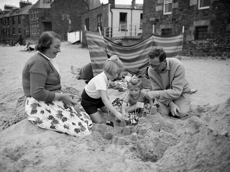 A family of holidaymakers at North Berwick, in East Lothian, building sandcastles in 1959.