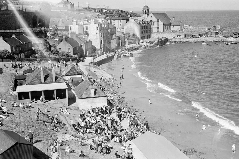 Tourists crowd onto the pier during high tide at Kinghorn Beach, in Fife, in June 1956.