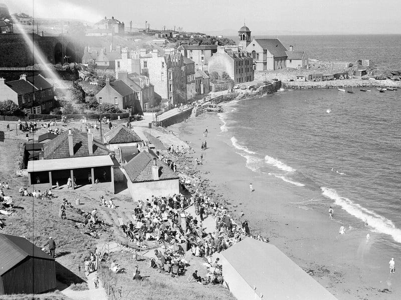 Tourists crowd onto the pier during high tide at Kinghorn Beach, in Fife, in June 1956.