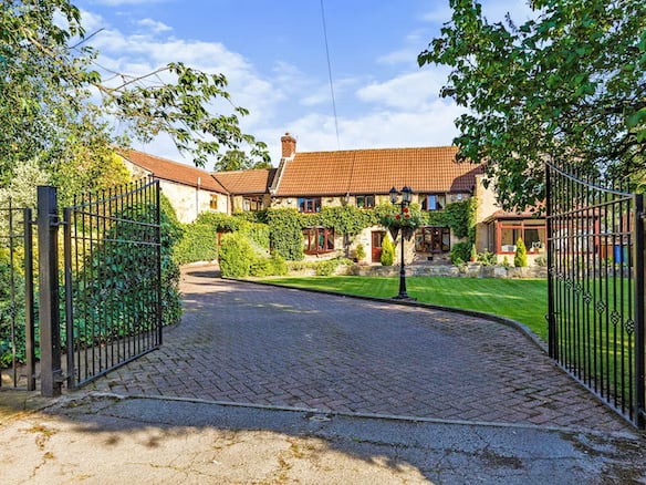 The house is found at the end of a winding, gated driveway.
