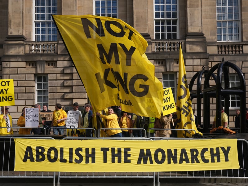 Anti-monarchy protesters gather along the Royal Mile ahead of a National Service of Thanksgiving and Dedication to the Coronation Of King Charles III And Queen Camilla.