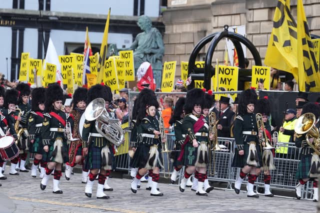The Combined Cadet Force Pipes and Drums and the Cadet Military Band proceed down The Royal Mile.