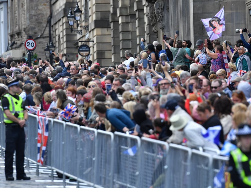 Members of the public gather to view the procession ahead of a National Service of Thanksgiving and Dedication to the coronation of King Charles III and Queen Camilla at St Giles' Cathedral.
