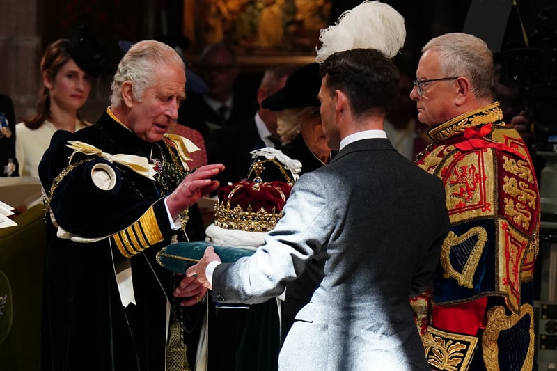 King Charles III is presented with the Crown of Scotland during the National Service of Thanksgiving and Dedication for King Charles III and Queen Camilla, and the presentation of the Honours of Scotland, at St Giles' Cathedral.