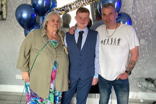 This young chap poses with his grandparents ahead of his prom
