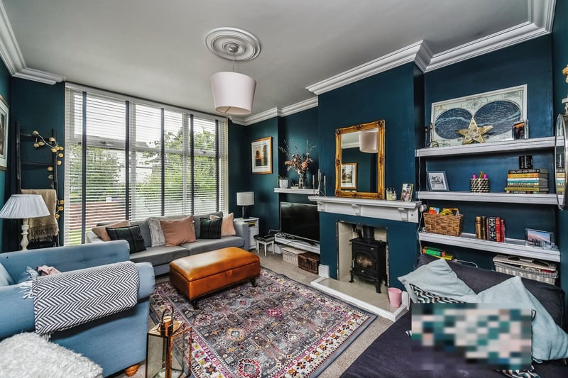 The spacious lounge with built-in bookshelves and woodburner looks like the ideal place to unwind in the evening with family or entertain guests.
