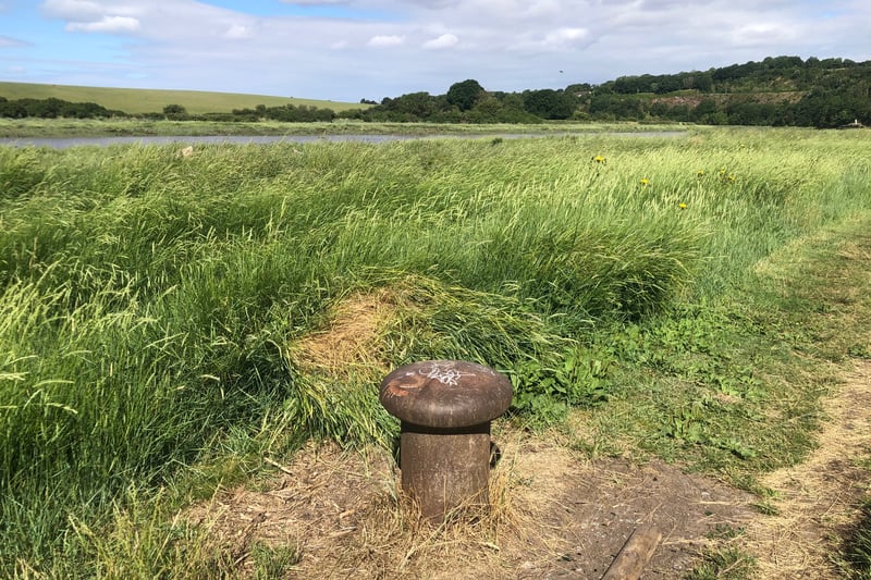 Large bollards, some dated 1930, can be seen close to the path. These were installed in response to a number of shipping accidents on the river.