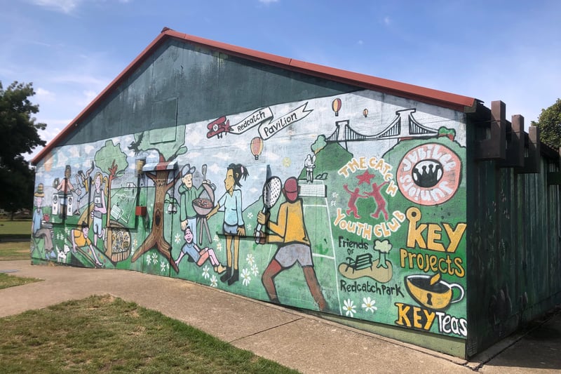 A colourful mural on the front of Redcatch Park Pavilion next to the community garden.