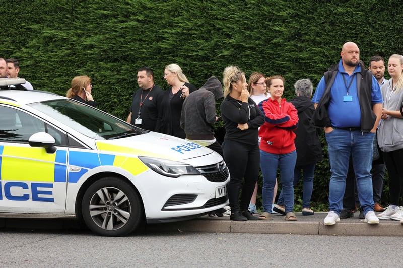 Parents and staff stand outside the school gates during the lockdown