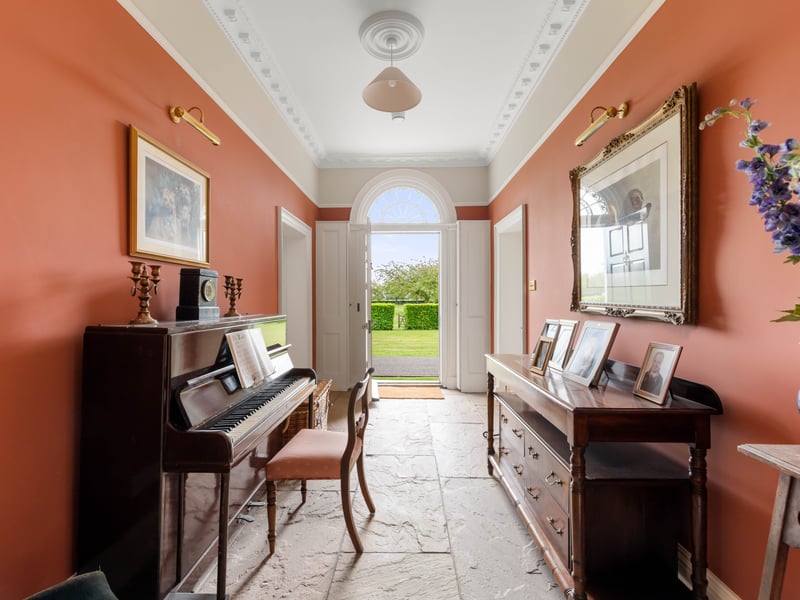 A room with a beautiful grand piano leads out to property’s grounds