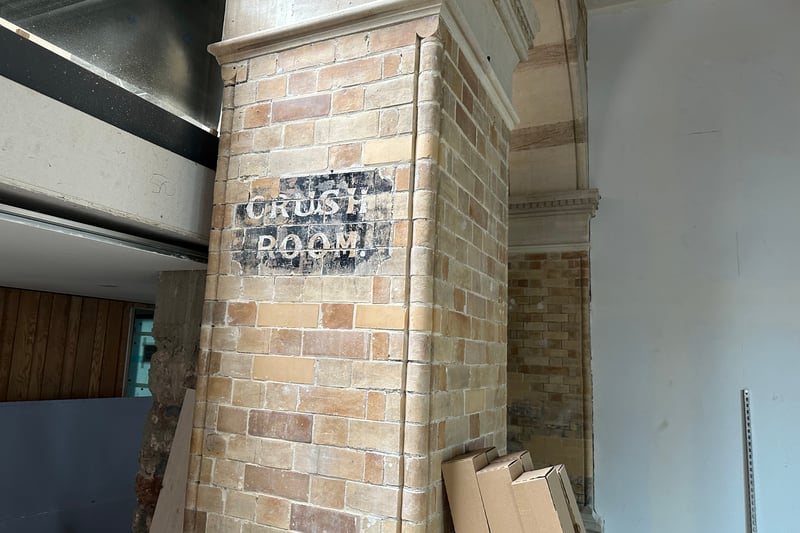 This historic sign for a crush room - thought to be a place where women had their dresses crushed down for seating - will remain on view