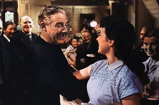 American actor Paul Douglas (1907 - 1959) is persuaded to join in the local dancing by Fiona Clyne in the light-hearted comedy ‘The Maggie’, released in 1954 and filmed on location in and around Glasgow. The film centres around a top level American executive (Douglas) trying to operate in a tiny Scottish village. Alternatively titled ‘Highland Fling’ or ‘High and Dry’, the film was directed by Alexander Mackendrick for Ealing Studios.