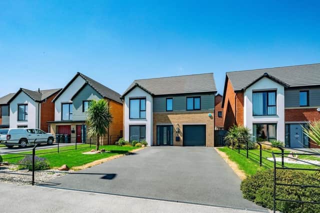 The driveway for this "stunning" property has space for up to six cars.